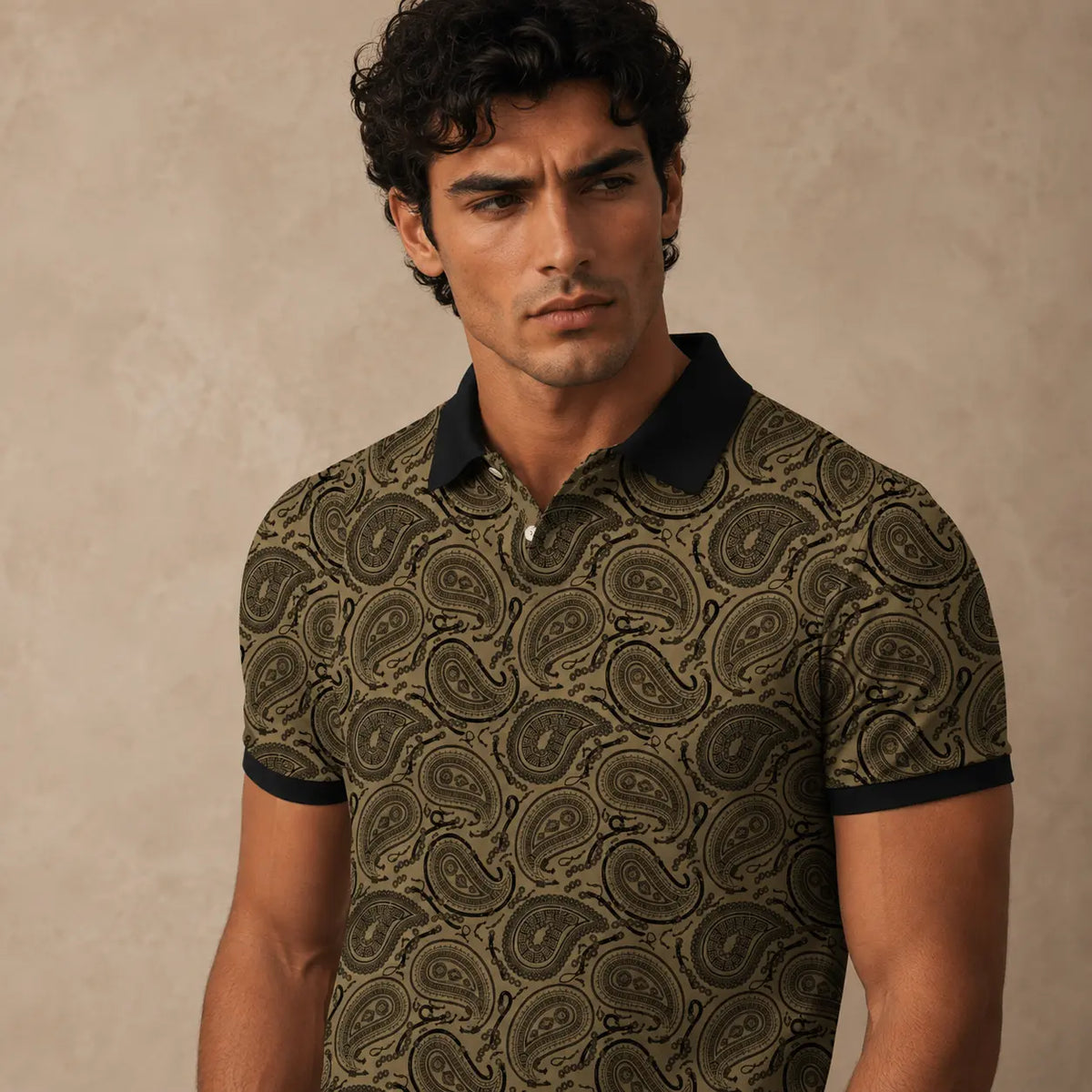 Man wearing a patterned polo shirt against a beige background