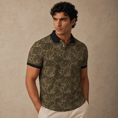 Man wearing a patterned polo shirt against a beige background
