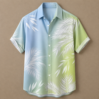A short-sleeve button-up shirt with a tropical palm leaf print, featuring a gradient color scheme from light blue on the left to light green on the right, displayed against a solid brown background.