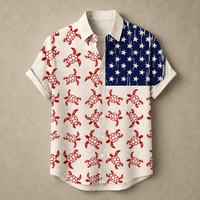 A short-sleeve button-up shirt laid flat on a textured beige background. The shirt has an off-white base with a repeating red turtle print on the left side and a navy blue field with white stars on the right side, styled like a stylized American flag.