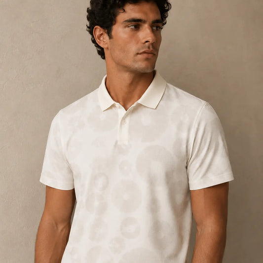 Man wearing a white polo shirt against a beige background