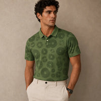 Man wearing a green patterned polo shirt against a beige background