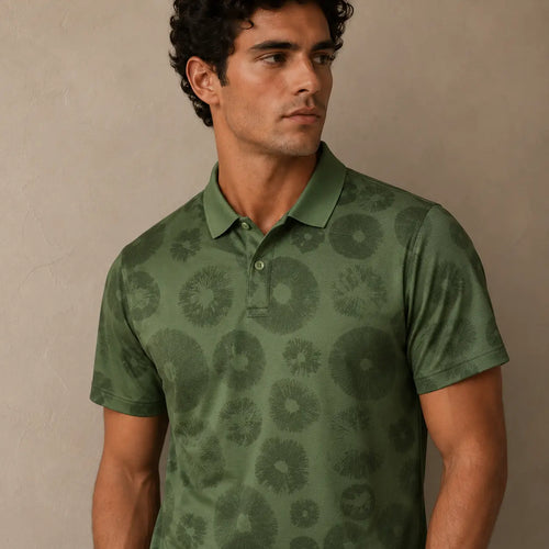 Man wearing a green patterned polo shirt against a beige background