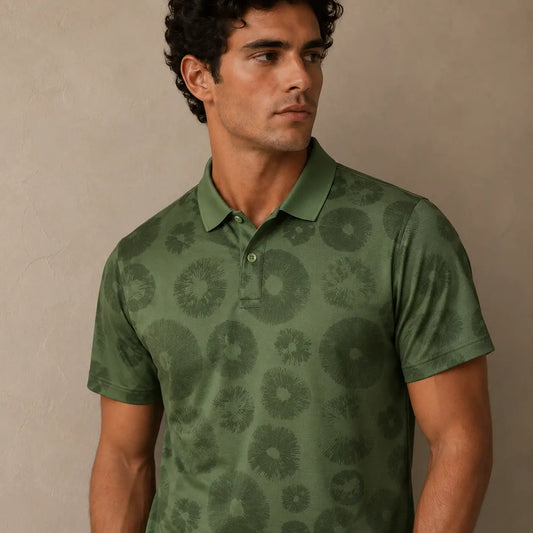 Man wearing a green patterned polo shirt against a beige background