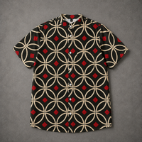 A short-sleeve button-up camp shirt with a black base, beige interlocking circle pattern, and red diamond accents, laid flat on a textured gray background.