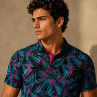 Man wearing a patterned shirt against a beige wall