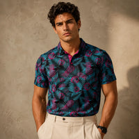 Man wearing a patterned shirt against a textured wall