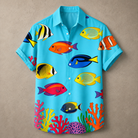 A short-sleeve button-up shirt in bright turquoise blue, covered with a colorful tropical fish and coral print, displayed flat against a textured beige background.