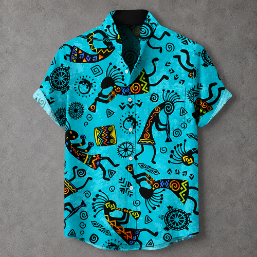 A short-sleeve button-up shirt in bright turquoise blue, featuring a bold black, yellow, and orange geometric and tribal-inspired print, laid flat on a textured gray background.