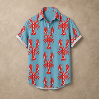 A short-sleeve button-up shirt in light blue with a repeating red lobster print, laid flat against a textured beige background.