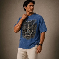 Man wearing a blue t-shirt with a graphic design on a brown background