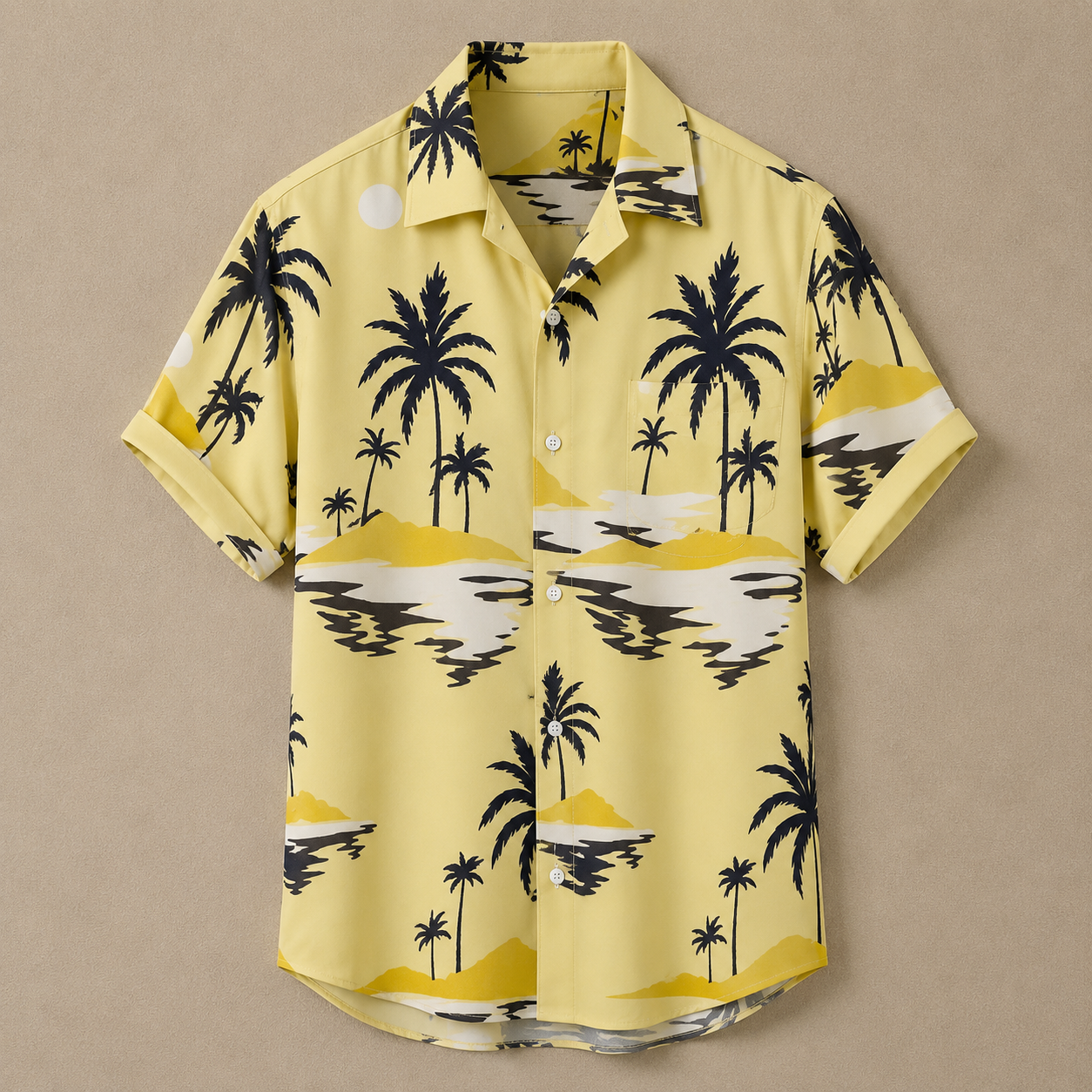 A short-sleeve button-up camp shirt in pale yellow with a black and white palm tree and beach landscape print, laid flat against a neutral beige background.
